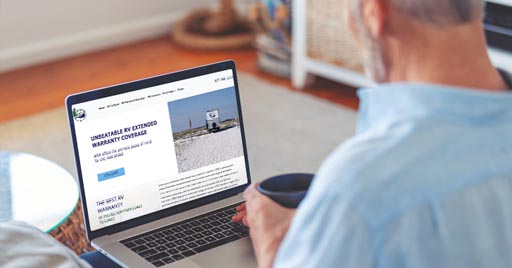 RV water and power hookups with hose and power cable attached.